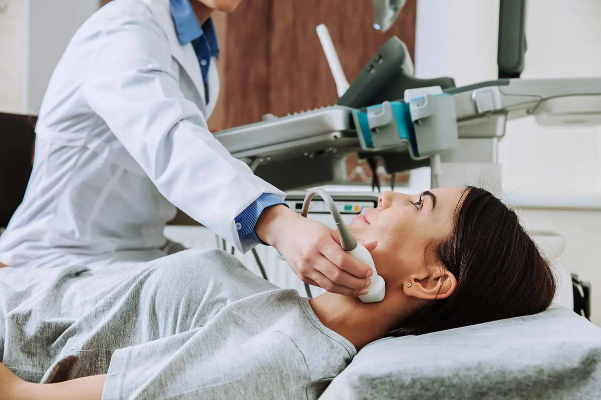 A patient receives an ultrasound of the thyroid at her endocrinologist’s office