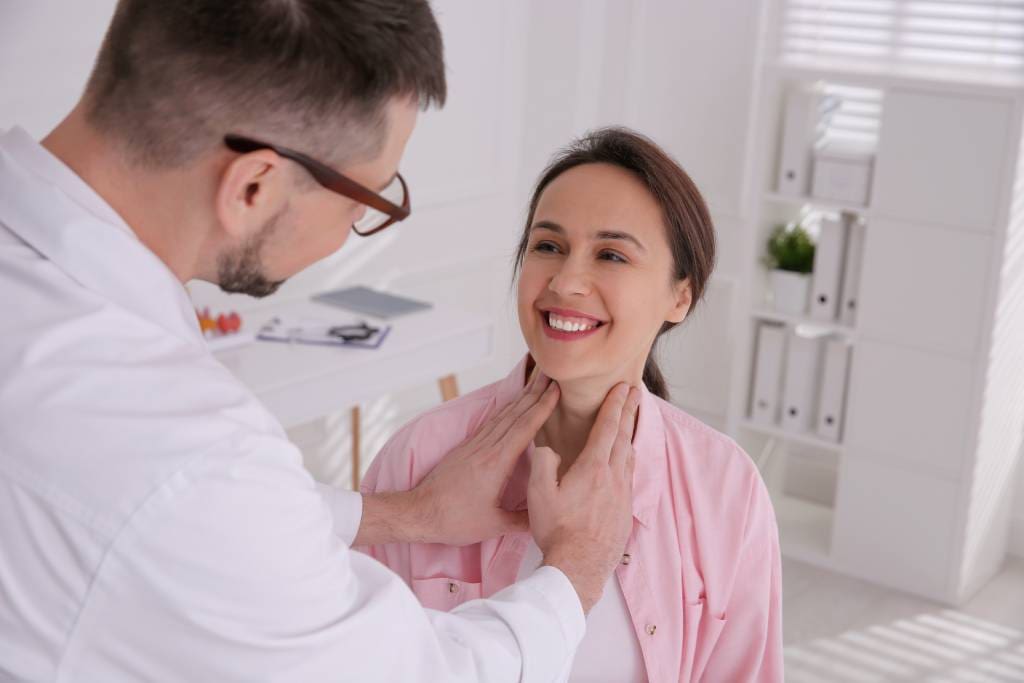 A satisfied patient at a follow-up appointment after RFA for thyroid nodules.