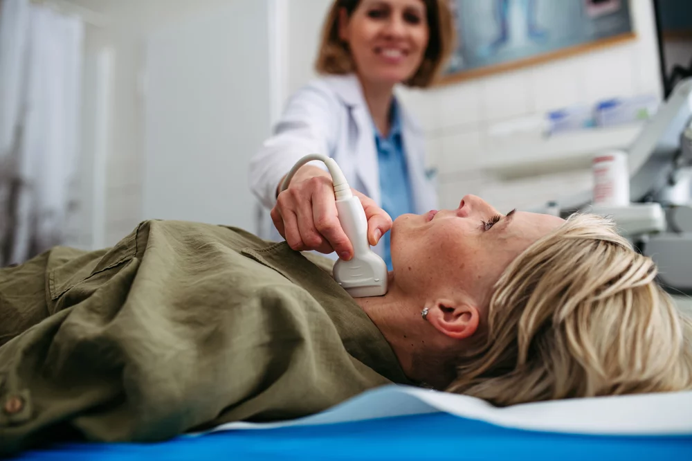 A patient with suspected nodules undergoes a thyroid ultrasound examination.
