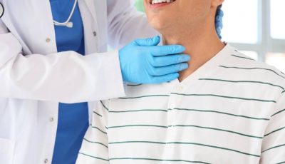 A patient smiles as a clinician examines his healthy thyroid following an RFA procedure.